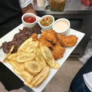 A plate with fried chicken, fries and dipping sauce.