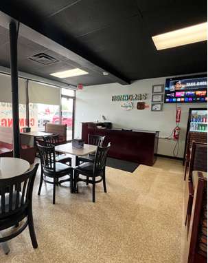 The interior of a restaurant with tables and chairs.