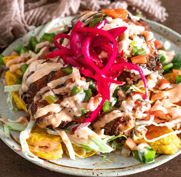 A plate with chicken and vegetables on it.