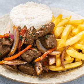 A plate with beef, fries and peppers.