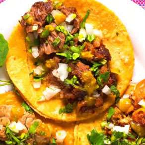 Three tacos with meat on a plate.